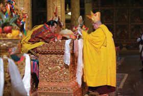 His Holiness the Je Khenpo, Trulku Jigme Choedra, makes the offerings of empowerment to His Majesty the King